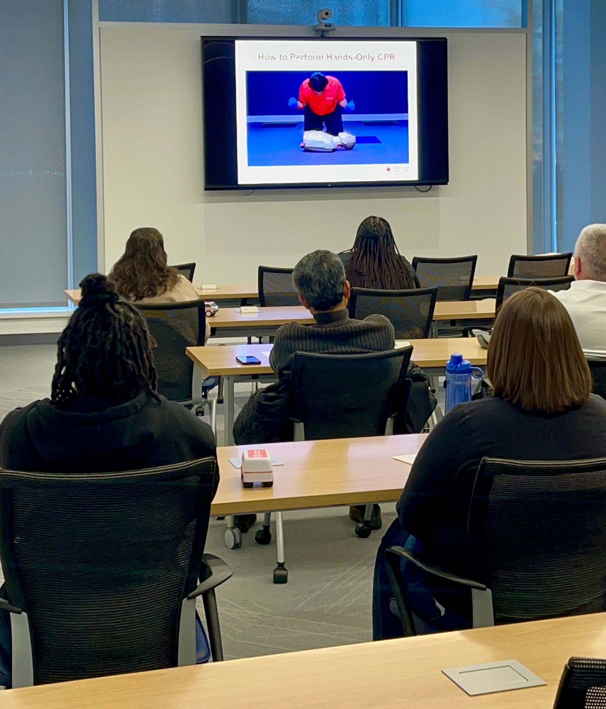 Participants watching a CPR training presentation in a classroom setting